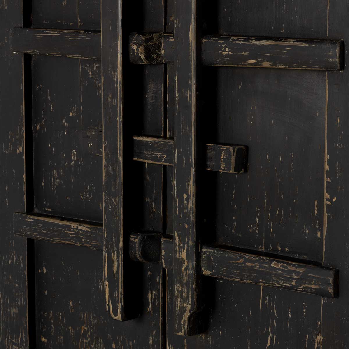 Close-up of a dark wooden door with wooden hardware