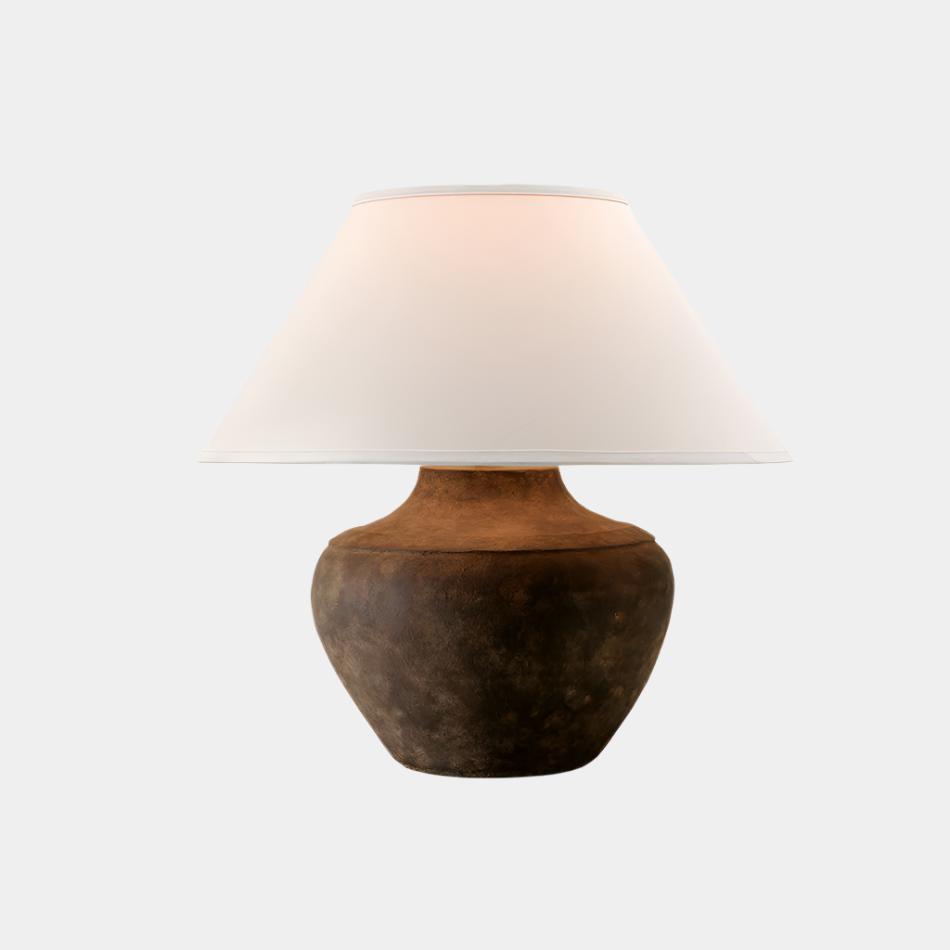 A table lamp with a brown ceramic base and a white linen shade.
