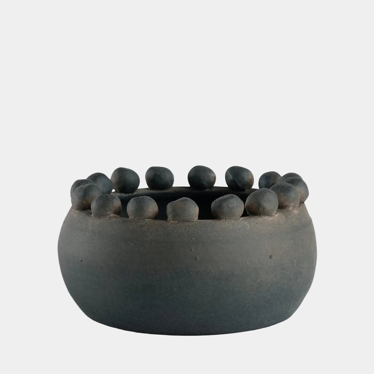 Ceramic planter with small balls on a white background