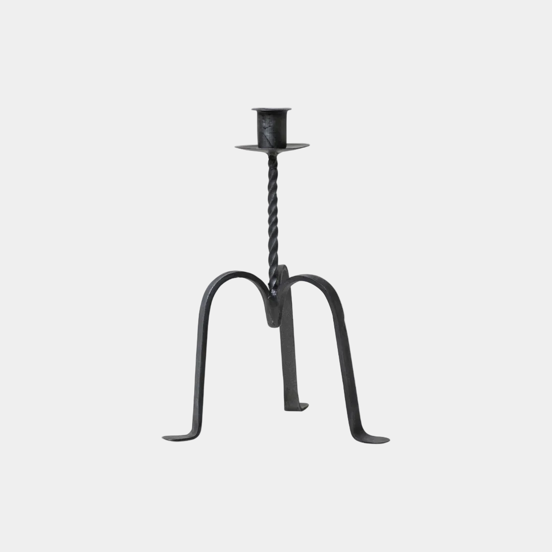 Black wrought iron candle holder with twisted design on a white background
