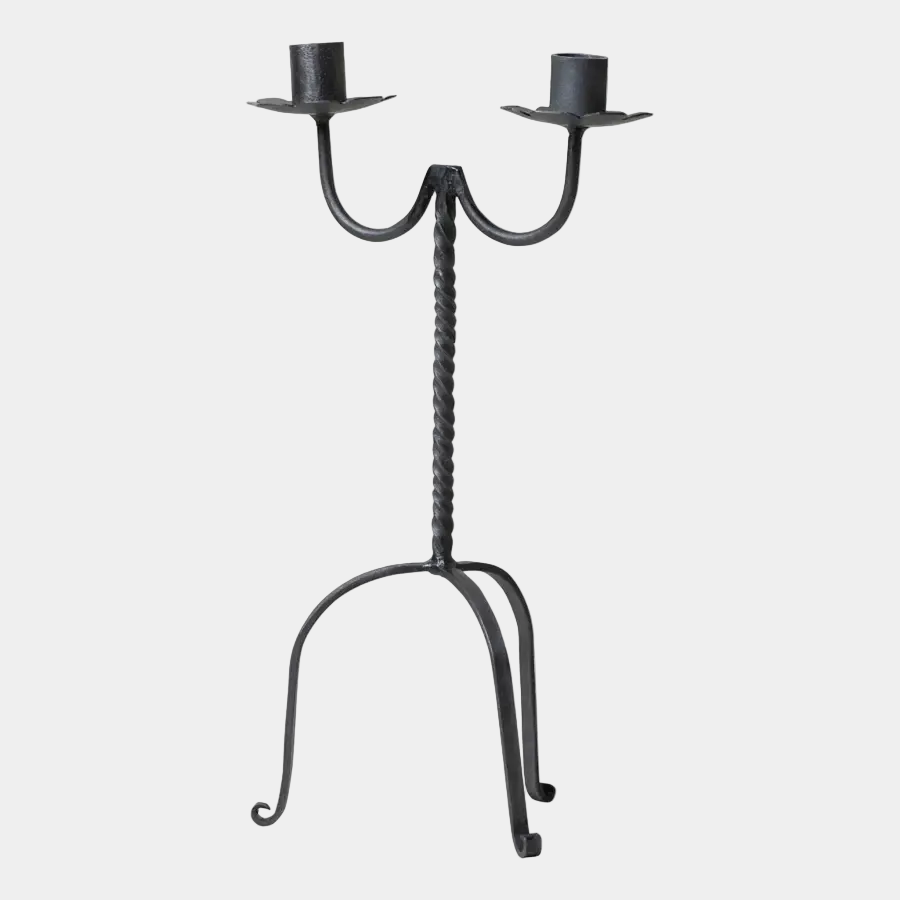 Black wrought iron candelabra with two candle holders on a white background