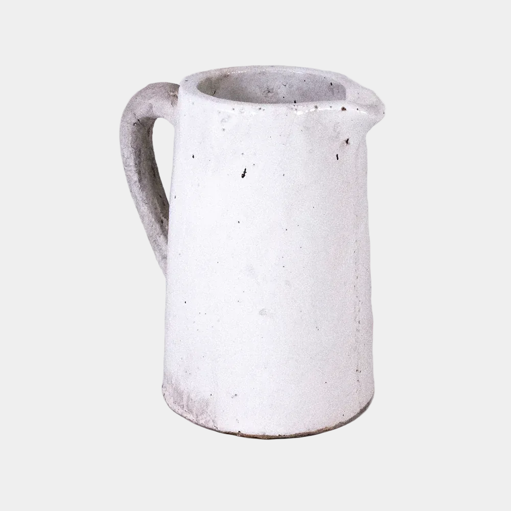 White ceramic pitcher with gray speckles on a white background