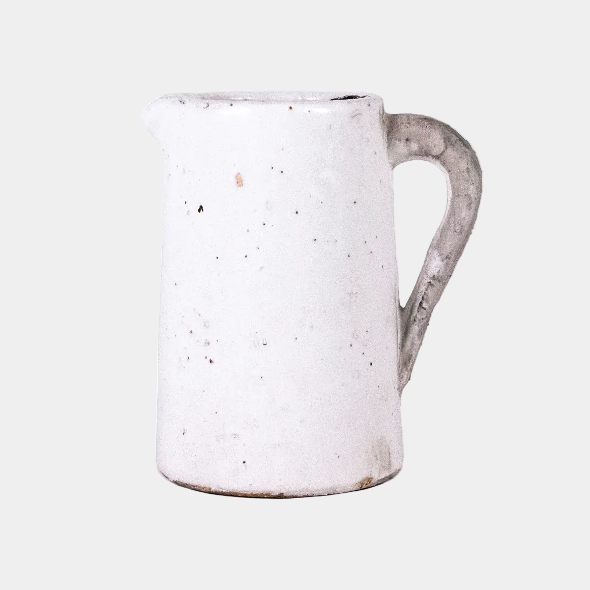 White ceramic pitcher with speckled texture on a white background