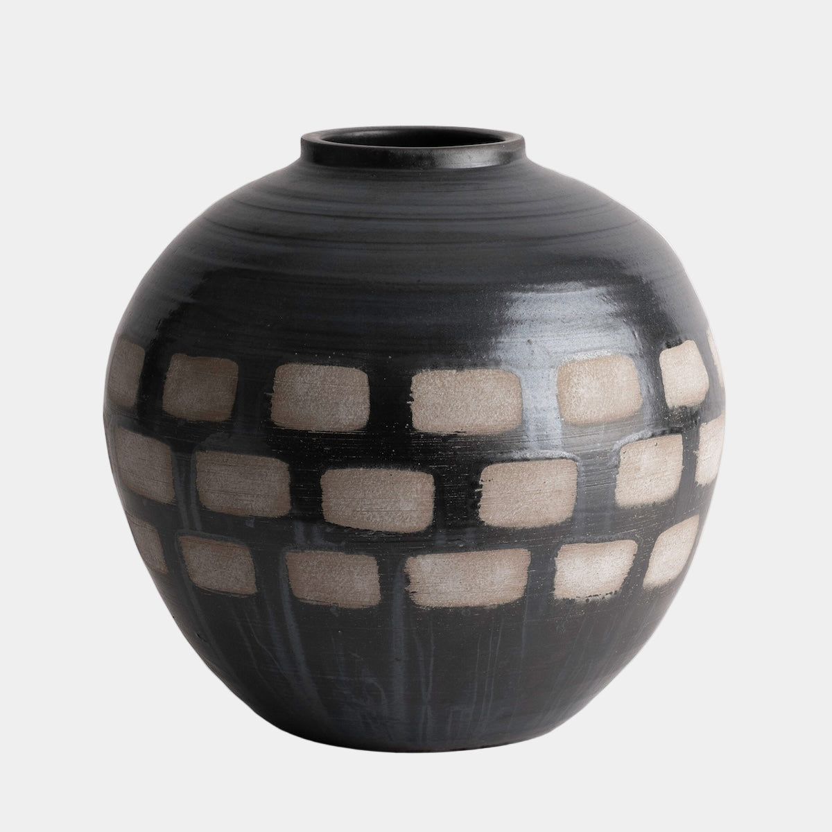 Black ceramic vase with white checkered pattern on a white background