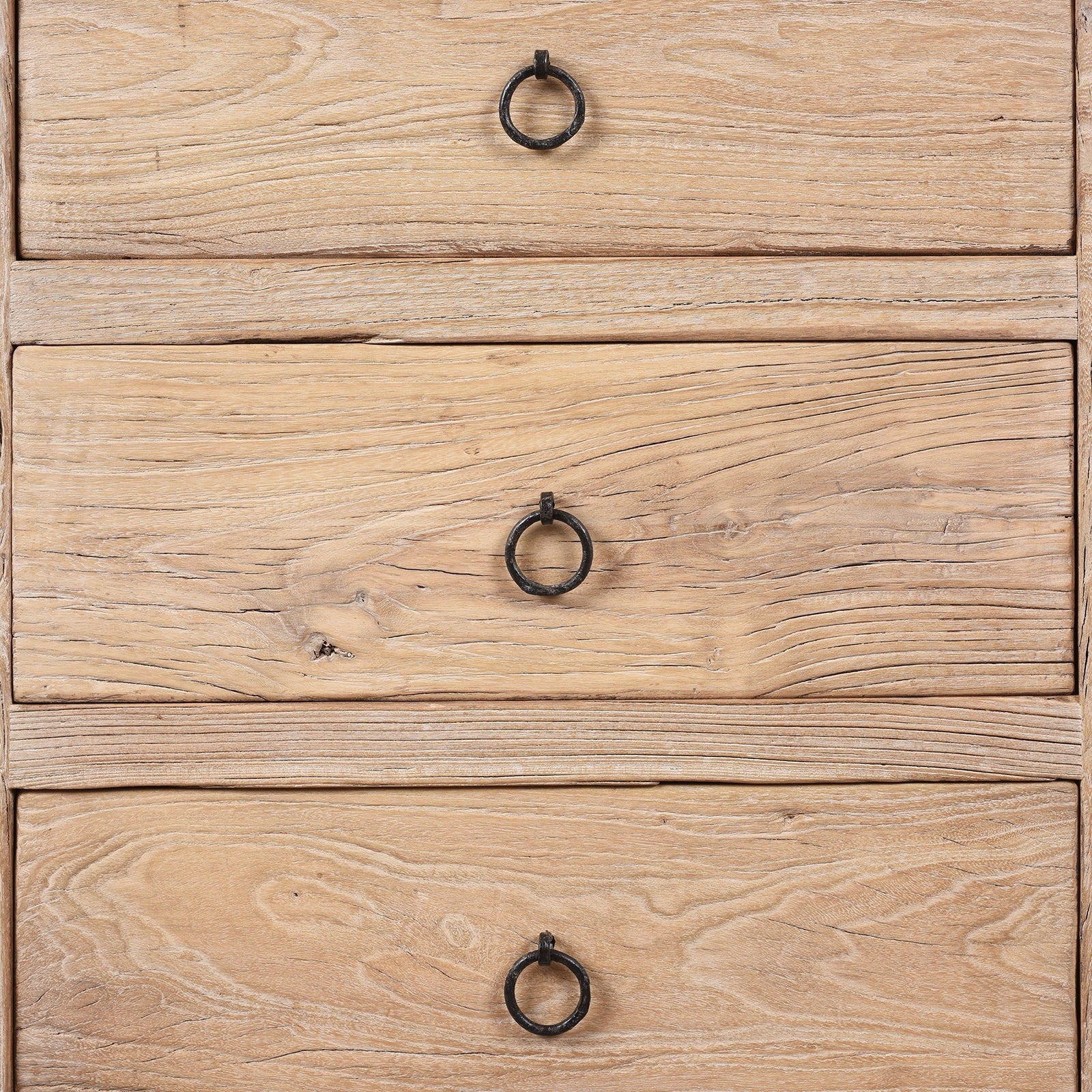 Close-up of a wooden nightstand with three drawers and metal handles.