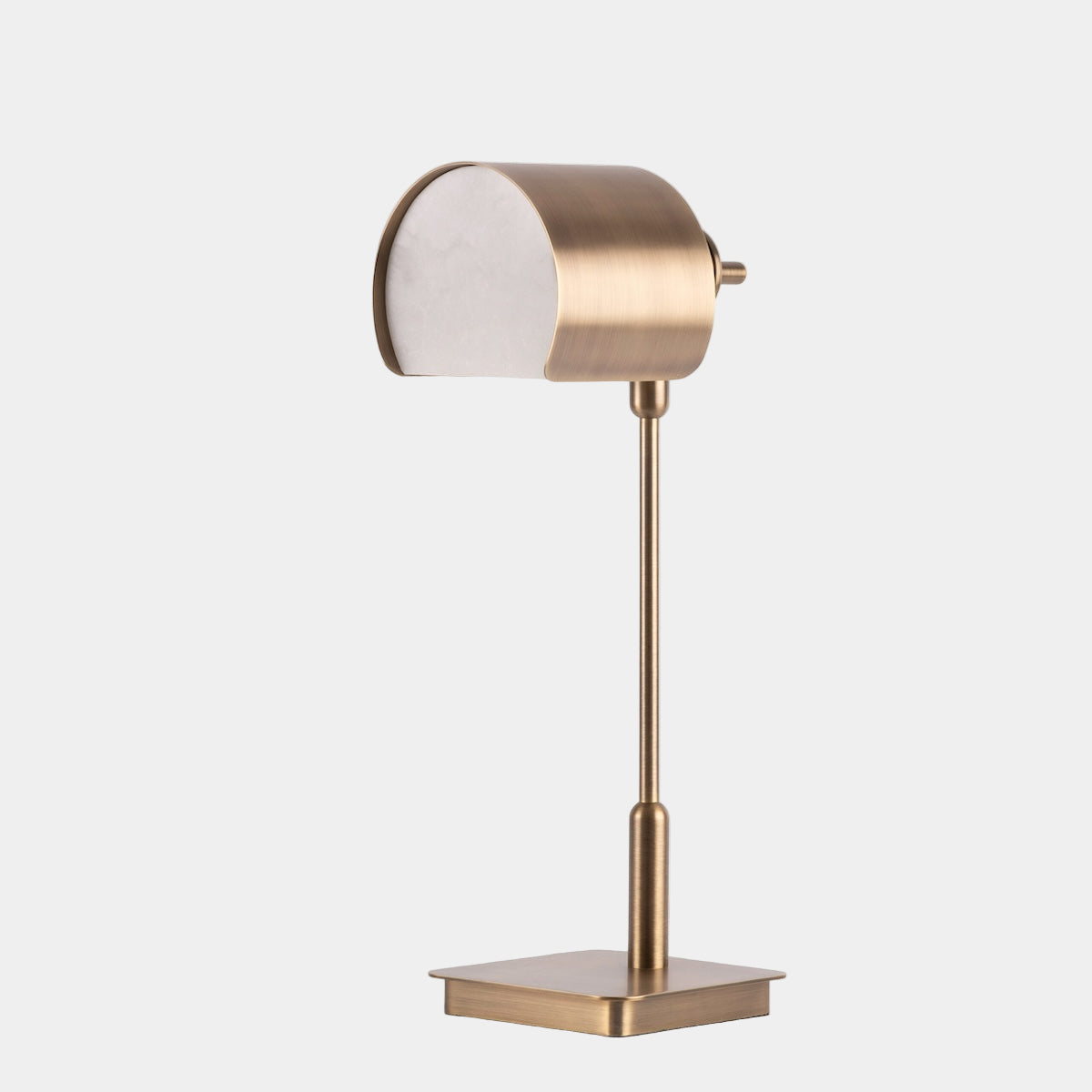 Modern table lamp with brass finish on a white background